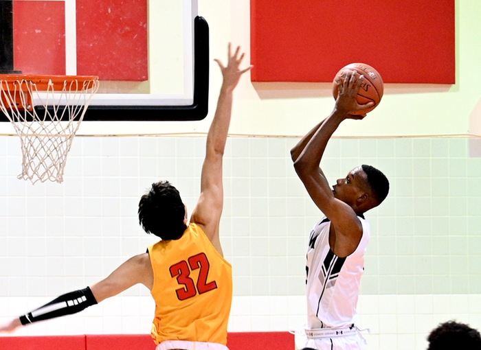 NMMI's Osborn Shema goes up for a short shot in the paint against NMJC's Joao Camargo. Photo courtesy of Jeremy Leaton.